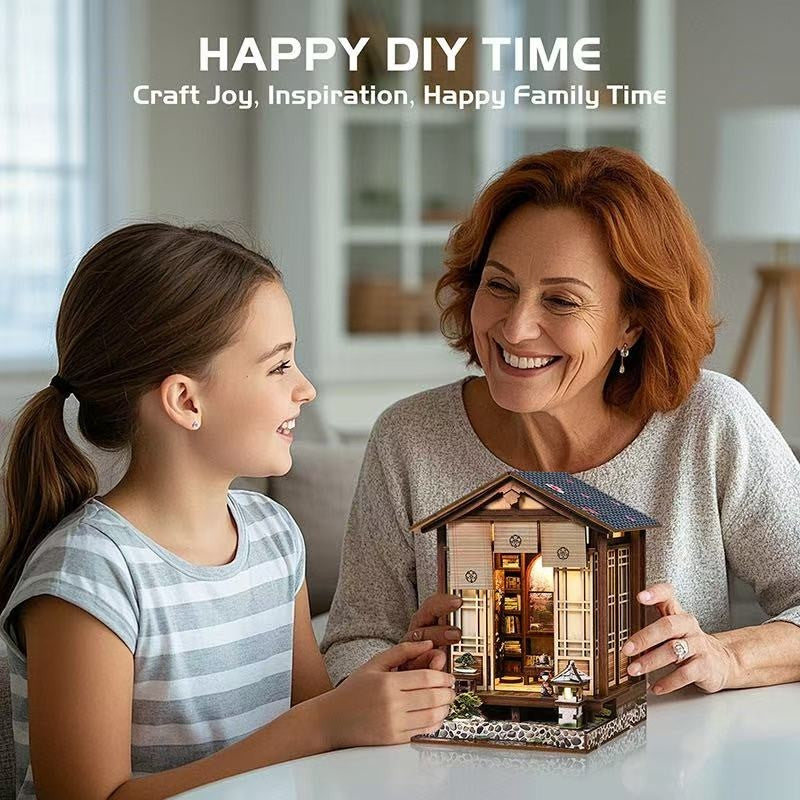 Woman and young girl holding a small wooden miniature house model with 'Happy DIY Time' text above.