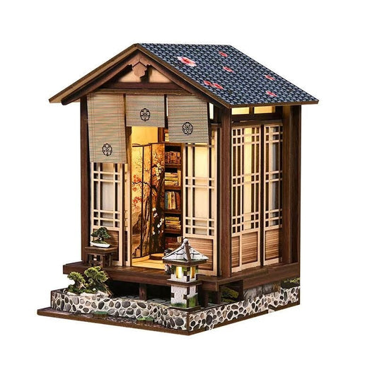 Miniature Japanese-style house model with detailed architecture and decorative elements on a white background