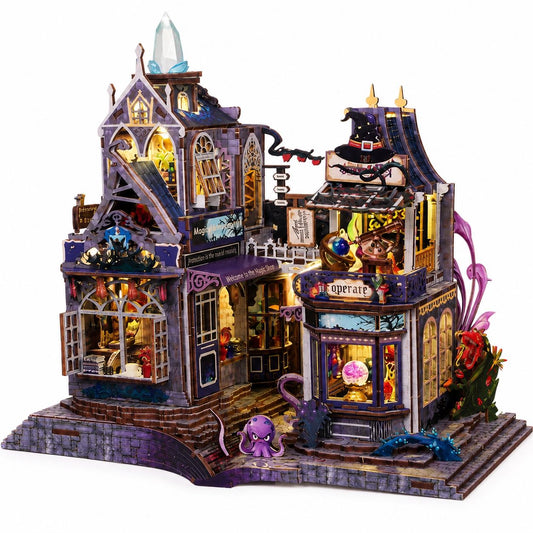 A detailed 3D wooden puzzle model of a whimsical, gothic-style haunted house with miniature details, lit windows, and small fantasy creatures, shown on a plain white background.