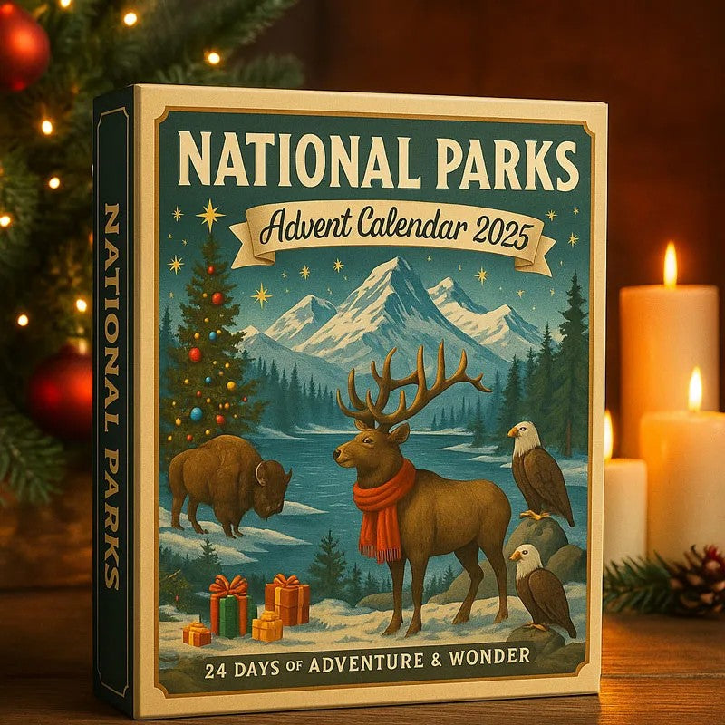 National Parks Advent Calendar 2025 with a deer, bison, and eagle illustration on a wooden surface with candles and Christmas decorations.