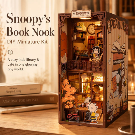 Snoopy's Book Nook DIY miniature kit with Snoopy and Charlie Brown figures on a wooden surface.