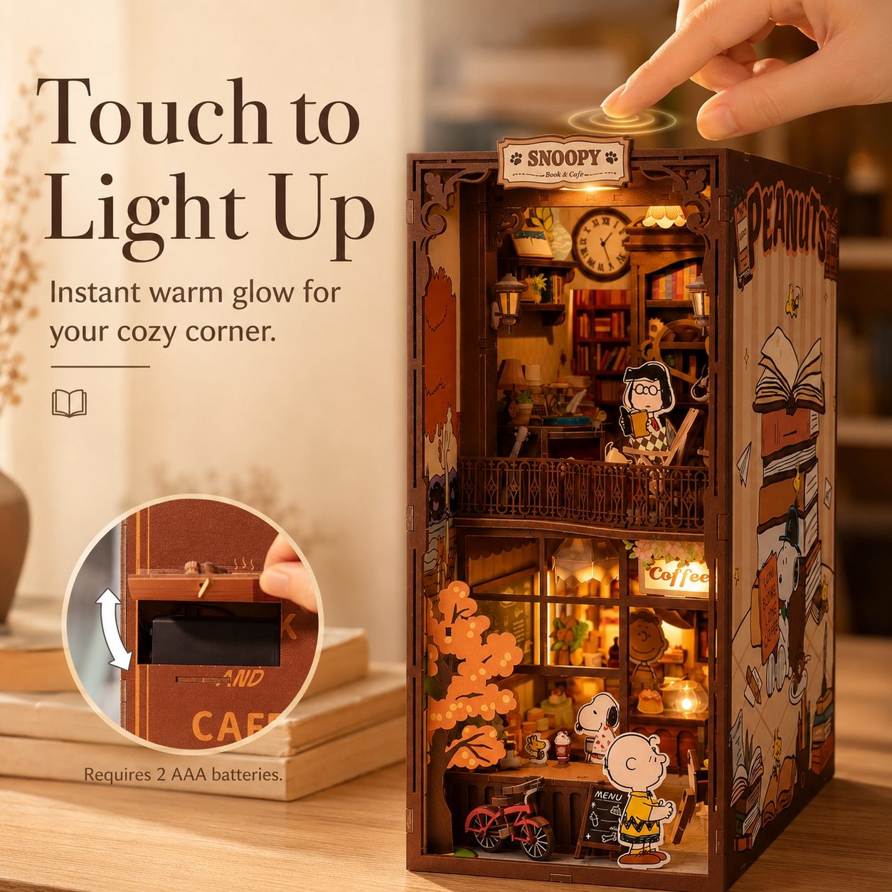 Wooden dollhouse with Snoopy and Peanuts characters, light-up feature, and hand touching the top.