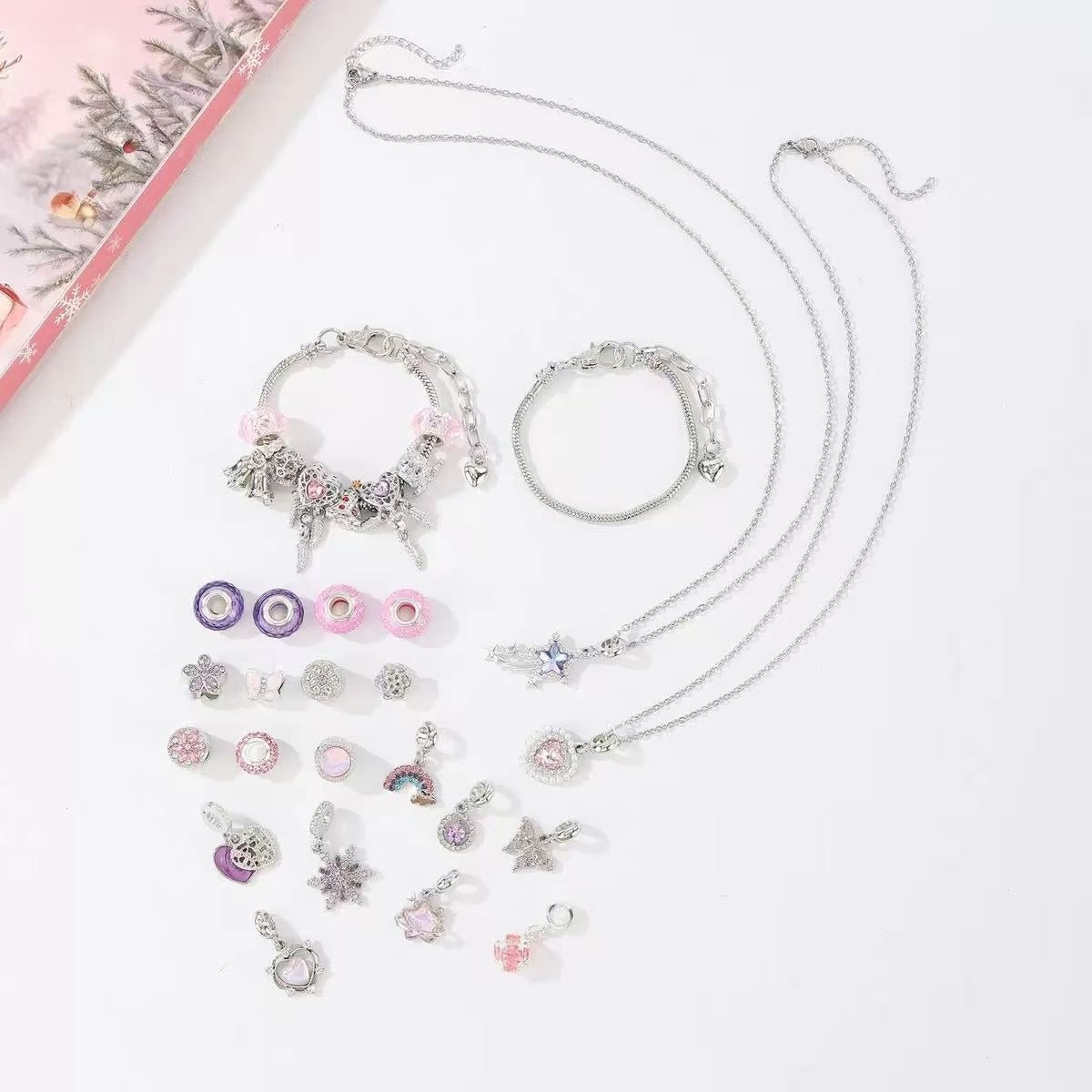 Jewelry set with necklaces and charms on a light background