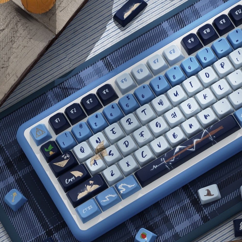 Close-up of a blue and white keyboard with decorative keycaps Inspired by one of the iconic Hogwarts house Ravenclaw on a textured surface.