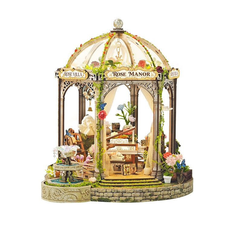 Detailed miniature house model of a garden gazebo with decorative elements on a white background