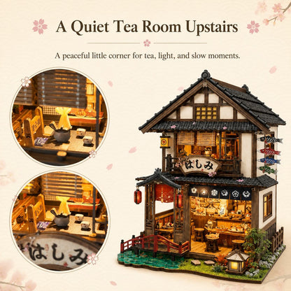A Japanese-style miniature tea room upstairs dollhouse with warm glowing interior lights, shown on a beige background with decorative text and two circular inset views of the detailed interior.