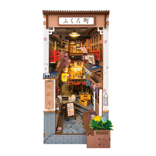 Miniature Book Nook of a Japanese street scene with shops and signs.