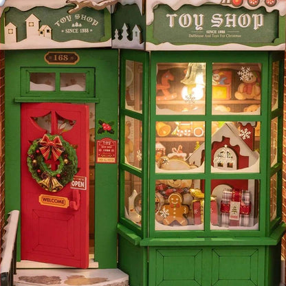 Miniature Christmas Toy shop display with a red door and green facade, featuring Christmas-themed toys.