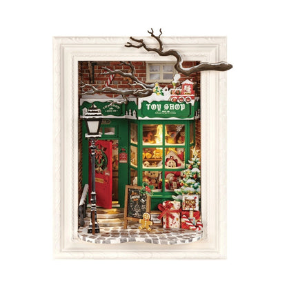 Miniature Christmas toy shop scene with a green door and festive decorations.