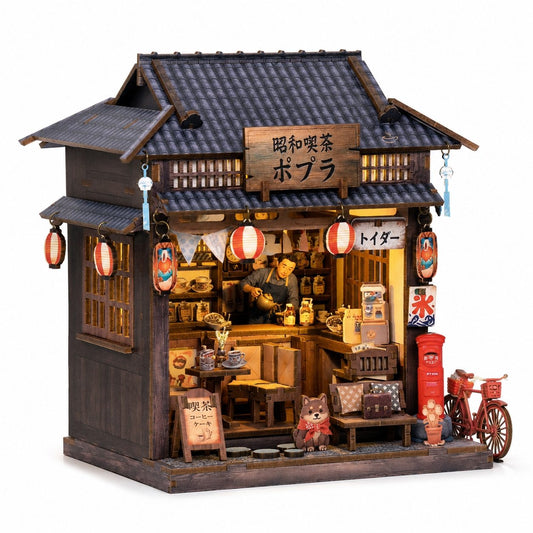 A miniature Japanese-style tea shop diorama with a dark wooden facade, tiled roof, hanging red lanterns, a visible shop interior with tiny figures and shelves, a red post box, and a small bicycle on the right, all shown on a plain white background.