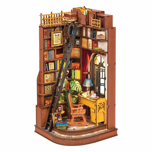 book nook model of a bookshelf with a desk and chair, filled with books and decorative items.