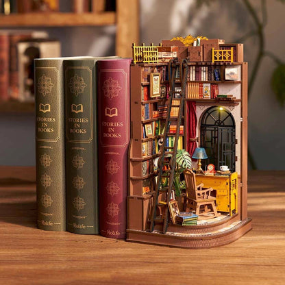 Miniature bookshelf model with books and interior details on a wooden surface