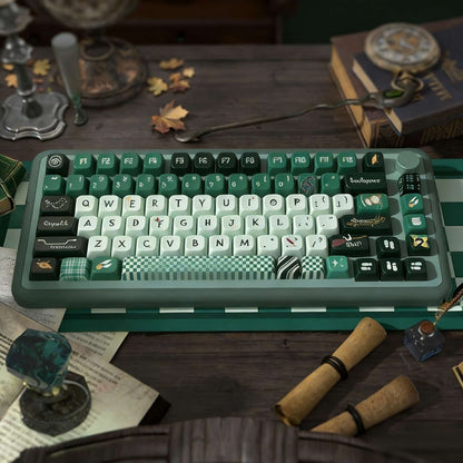 Mechanical keyboard with green keys Inspired by Slytherin in Harry Potter on a wooden table with decorative items