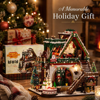 A decorated miniature Christmas lodge set displayed on a table beside its retail box, with a blurred Christmas tree, ornaments, and warm indoor lights in the background. Text on the image reads 'A Memorable Holiday Gift.