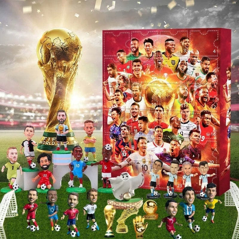 Collection of soccer player figurines with a large trophy and a advent calendar box on a grass field background