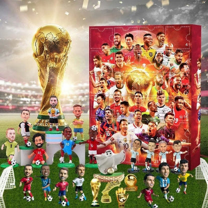 Collection of soccer player figurines with a large trophy and a advent calendar box on a grass field background