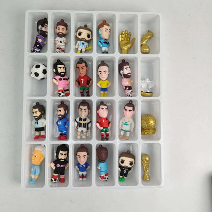 Collection of small soccer figurines and items in a advent calendar box