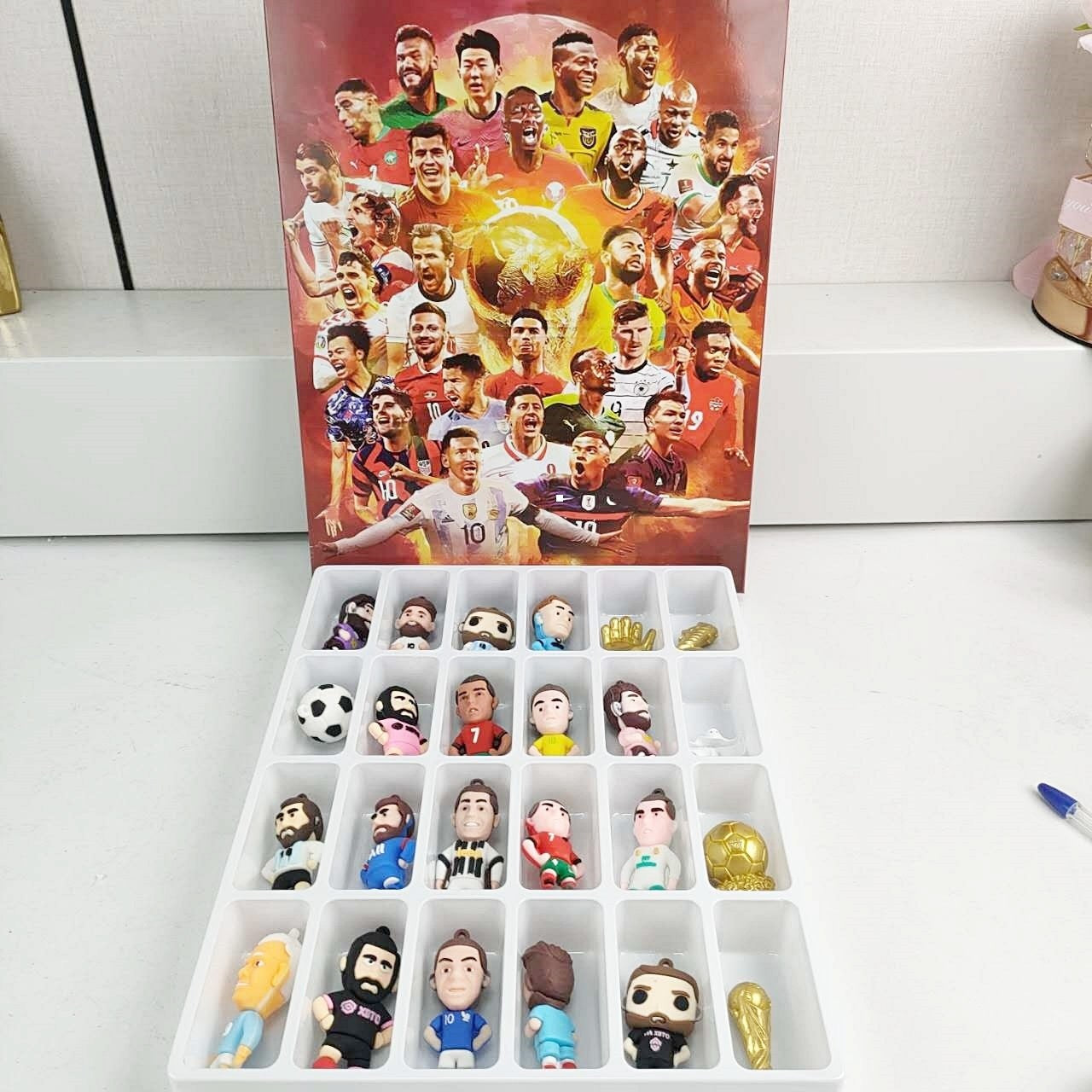 Collection of soccer player figurines in a soccer players advent calendar box