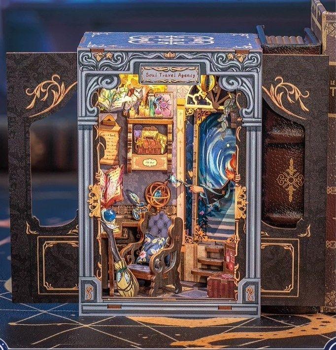 Soul Travel Agency DIY Book Nook Kit, a mystical miniature shop helps you to explore the soul and heal the heart through magical doors, complete with a touch-activated light and protective dust cover. Perfect for any book lover’s collection. Perfect for those who love the whimsical world, DIY enthusiasts, bookend lovers, model building lovers, dollhouse collectors, bookshelf insert decor.