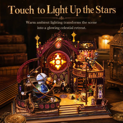 A miniature gothic-style celestial observatory and house light-up set displayed on a dark wooden surface. The scene includes warm glowing interior lights, stars, planets, books, and decorative props, with large text at the top reading 'Touch to Light Up the Stars.