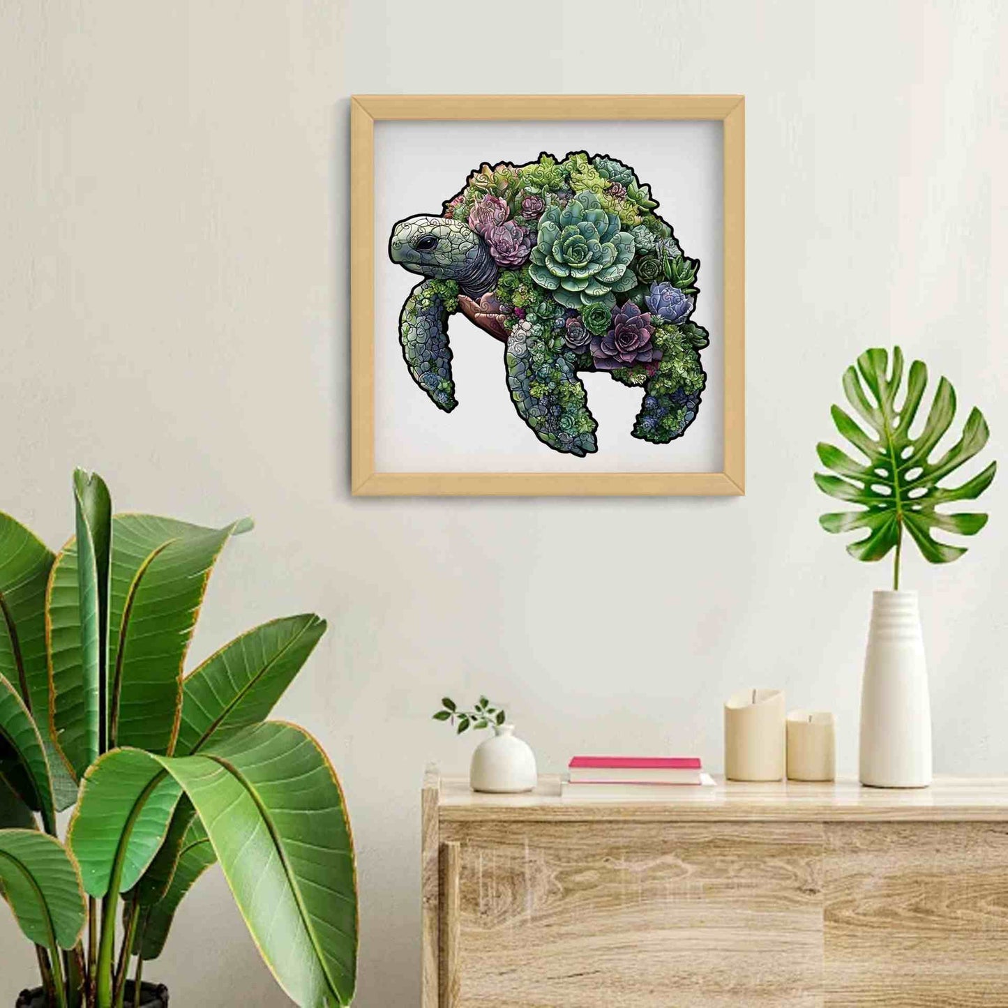 Framed wooden puzzle of a turtle made of succulents on a wall above a wooden table with plants.