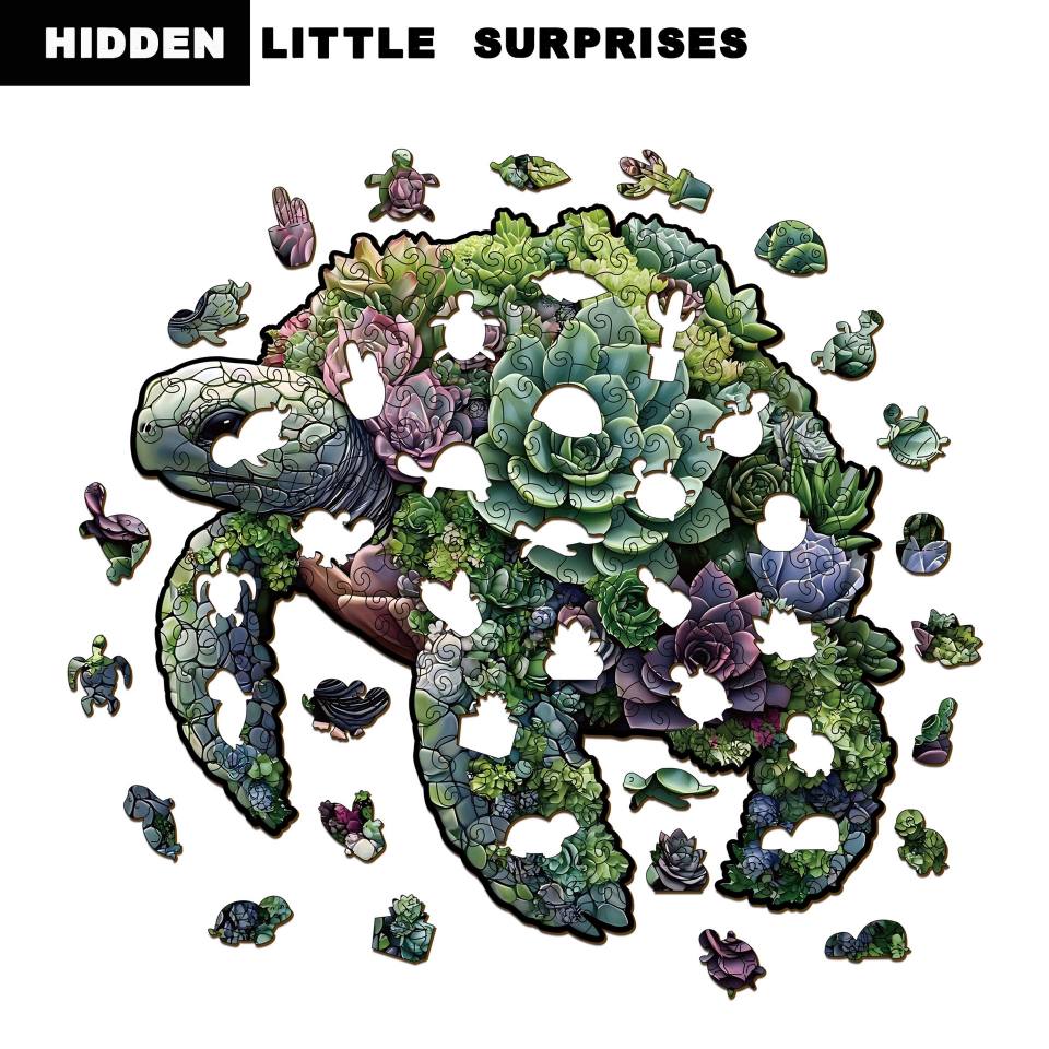 Jigsaw puzzle with a turtle design made of succulents on a white background, featuring the text 'Hidden Little Surprises'.