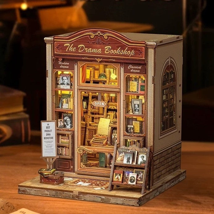 Miniature model of a bookshop named 'The Drama Bookshop' with warm light