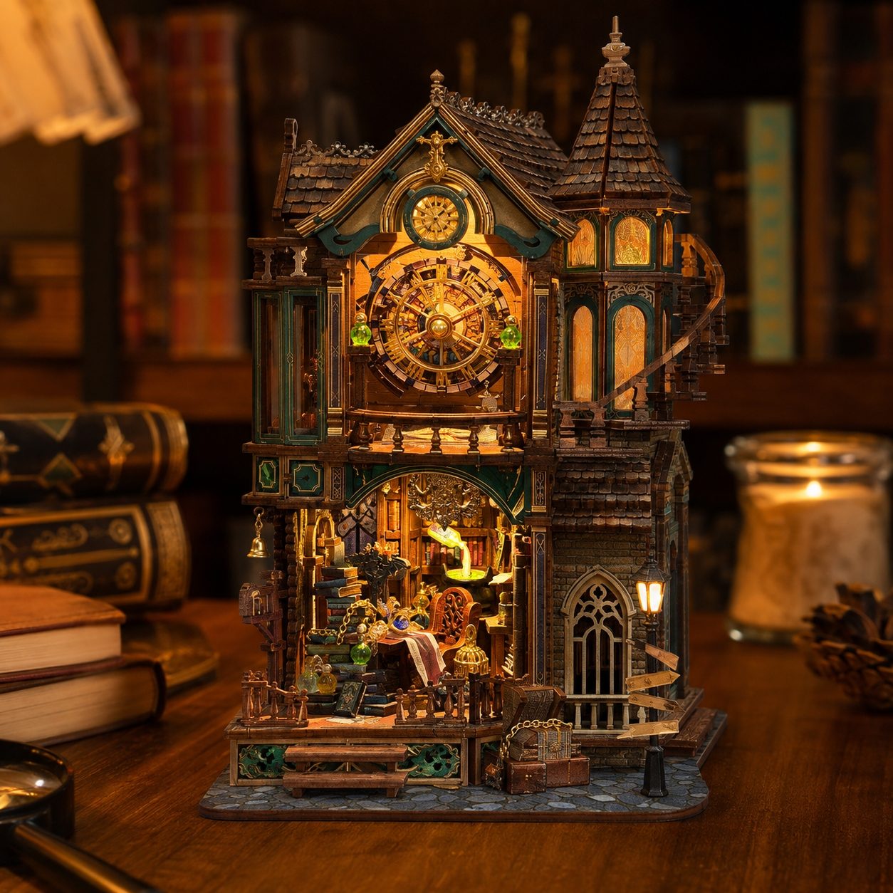 A miniature gothic house clock and lantern decoration displayed on a wooden table, with warm glowing lights inside and around it, set against a dark, cozy background of books and candles.