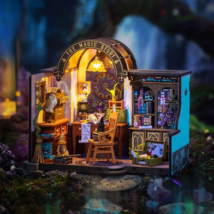 image displaying a finished The Magic Study DIY Miniature House Kit with lights on in magic-themed setting