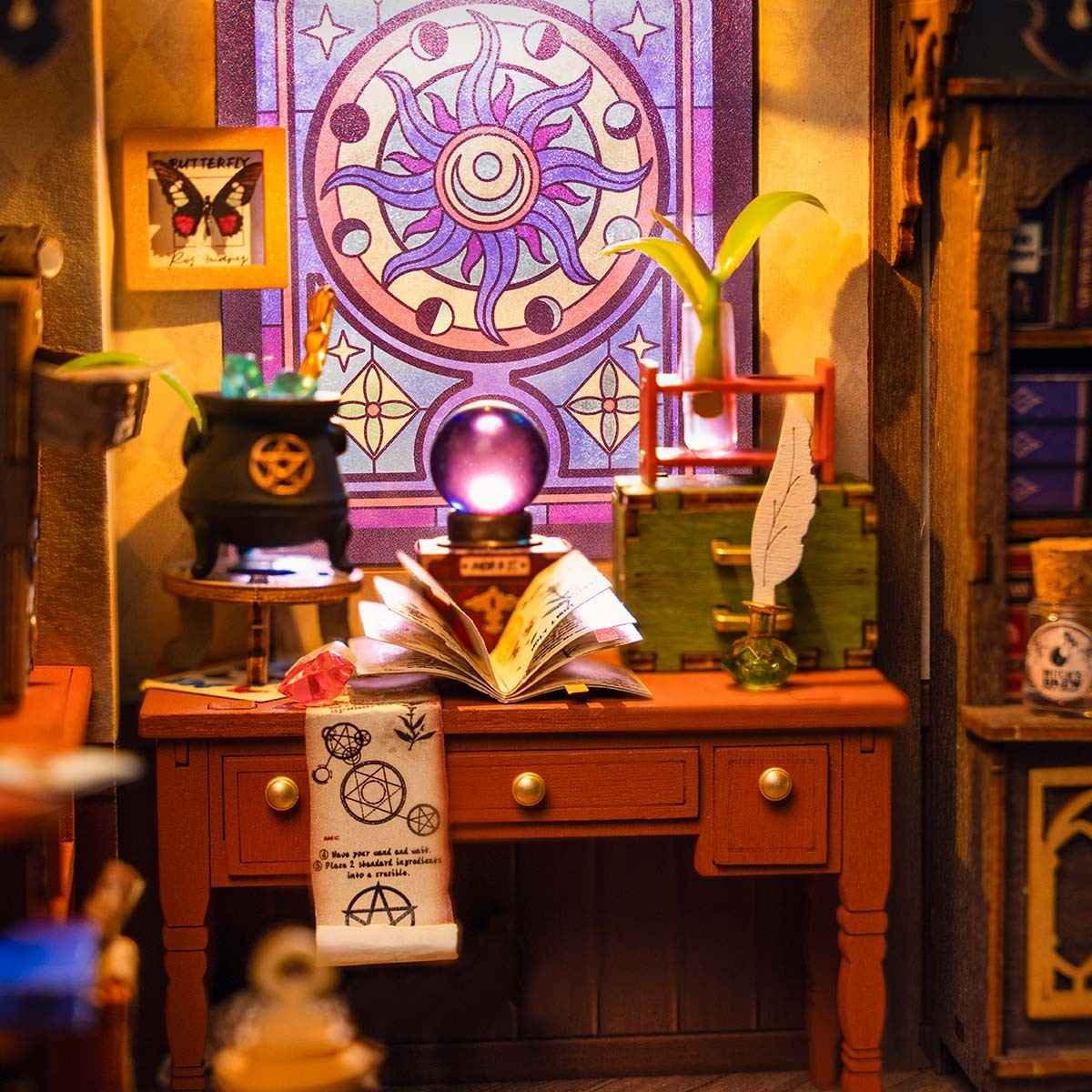 image displaying the miniature workbench with magic book, crystal globe, potions and so on in The Magic Study DIY Miniature House Kit with lights on