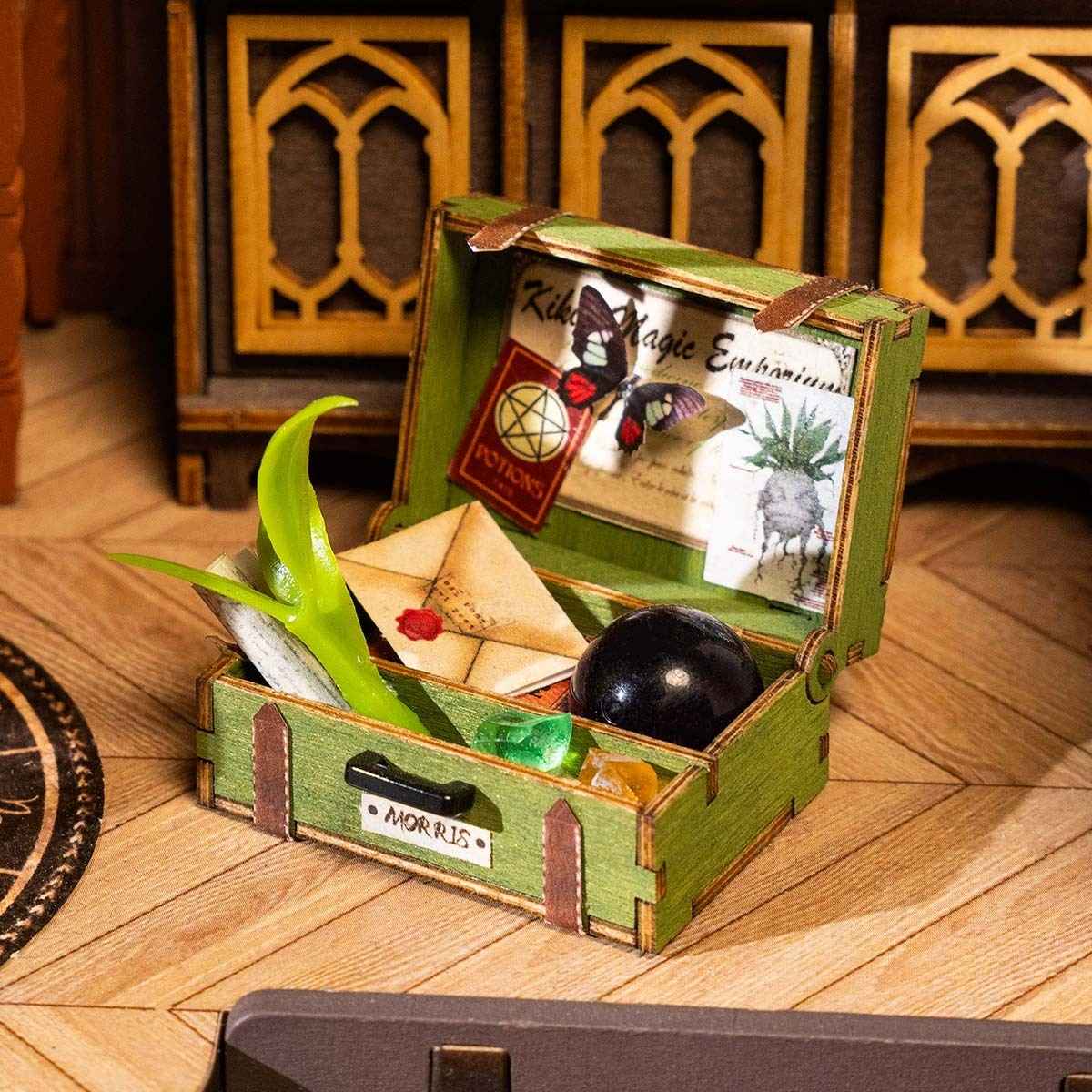 image displaying a miniature wooden case with grocery in The Magic Study DIY Miniature House Kit with lights on in magic-themed setting