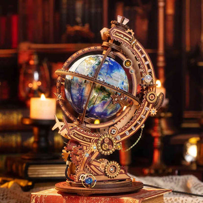 metal globe model kit with mechanical elements on a wooden base in a warm, candlelit room.