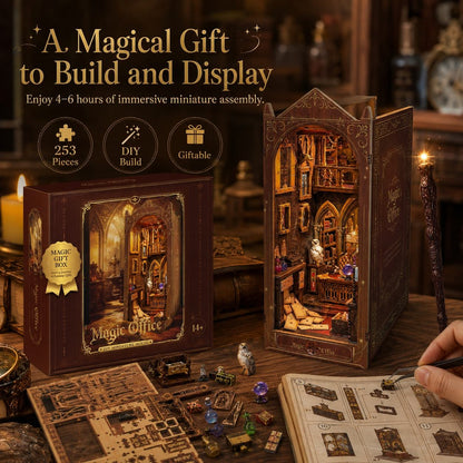 A magic-style miniature building kit shown assembled beside its box on a wooden table, with a hand holding a tool nearby. The scene includes promotional text, feature icons, and miniature accessories, suggesting a magical office or library diorama set.