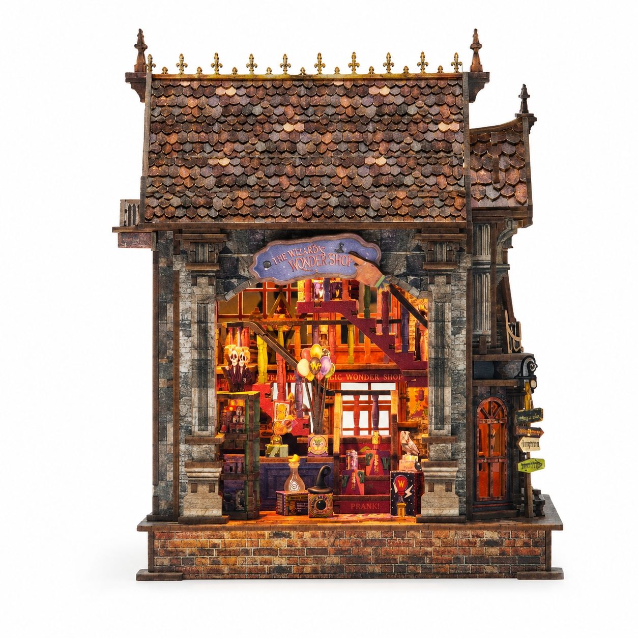 A detailed miniature diorama of a medieval shop, featuring a dark brown tiled roof, stone-textured walls, and a warmly lit interior with tiny figures and shelves, shown against a plain white background.