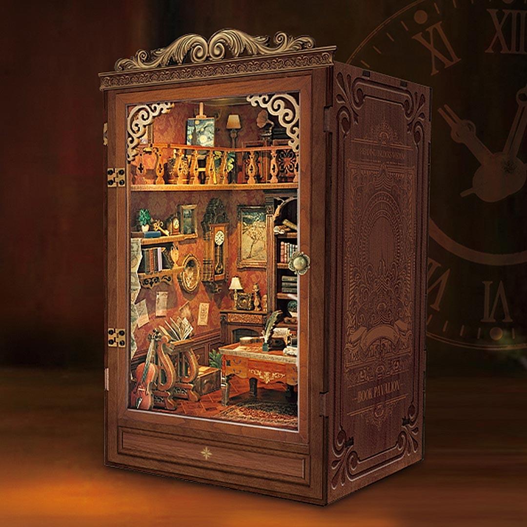 the assembled Time Book House Wooden Book Nook on table, casting warm light