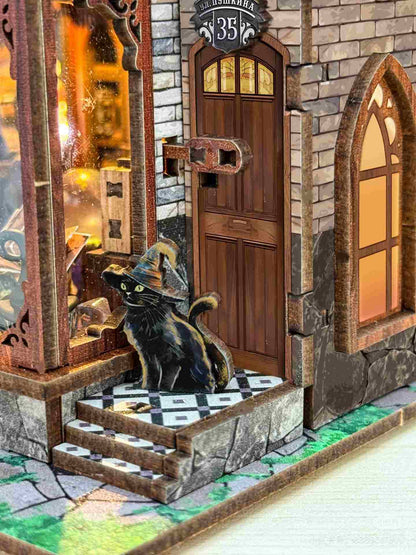 close up the miniature details of a stone building with a wooden door and a black cat on the steps