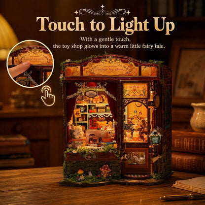 A miniature toy shop dollhouse with warm LED lighting, shown on a wooden table with promotional text reading 'Touch to Light Up' and a circular inset demonstrating a finger press to activate the glow.
