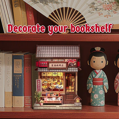 Decorative bookshelf with a small miniature house Japanese store, books, and dolls.