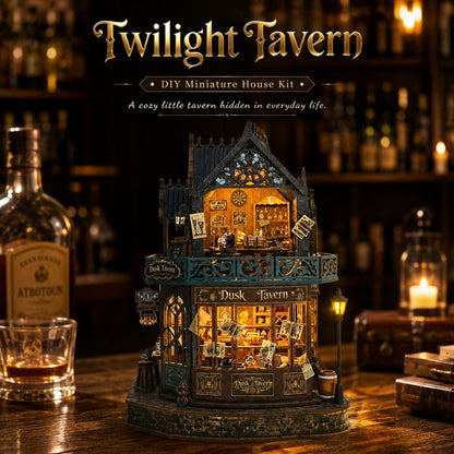 Twilight Tavern DIY miniature house kit displayed on a wooden bar counter in a dimly lit bar setting. The miniature two-story pub features glowing warm yellow interior lights, detailed shop windows, a balcony, and a dark teal and brown exterior.