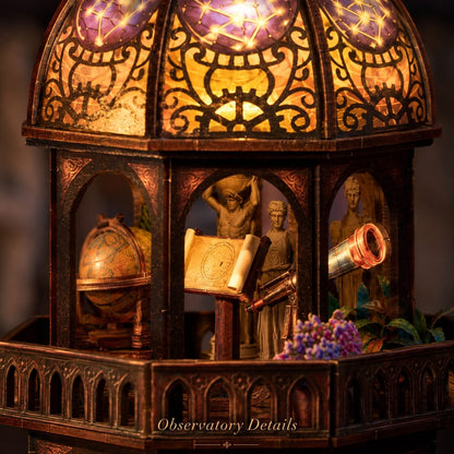 Close-up of a  observatory-style miniature house with a domed stained-glass top, warm internal lighting, miniature figurines, a globe, telescope, and small purple flowers. Text at the bottom reads 'Observatory Details'.