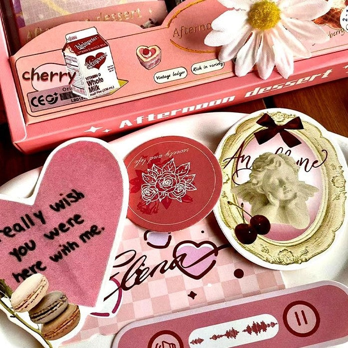 Pink DIY Journaling Kit items with text and graphics on a wooden surface