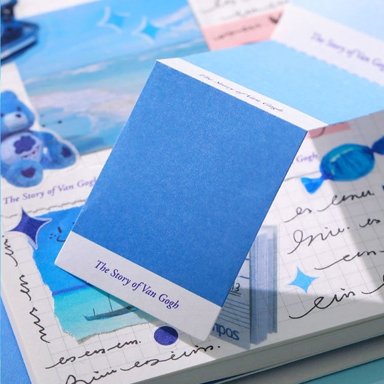 Blue color swatch book on top of a scrapbook with Van Gogh-themed content