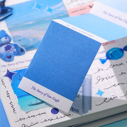 Blue color swatch book on top of a scrapbook with Van Gogh-themed content