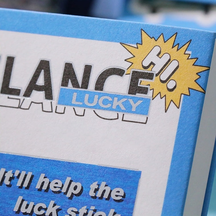 Journaling book with 'LANCE' and 'LUCKY' stickers, featuring a blue and yellow design.