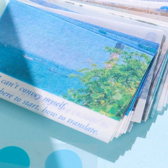 Stack of Washi sticker with a scenic view and text on a blue surface