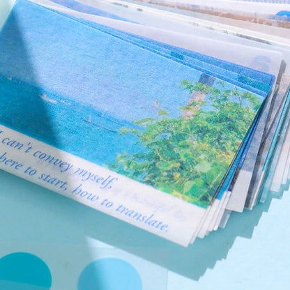 Stack of Washi sticker with a scenic view and text on a blue surface