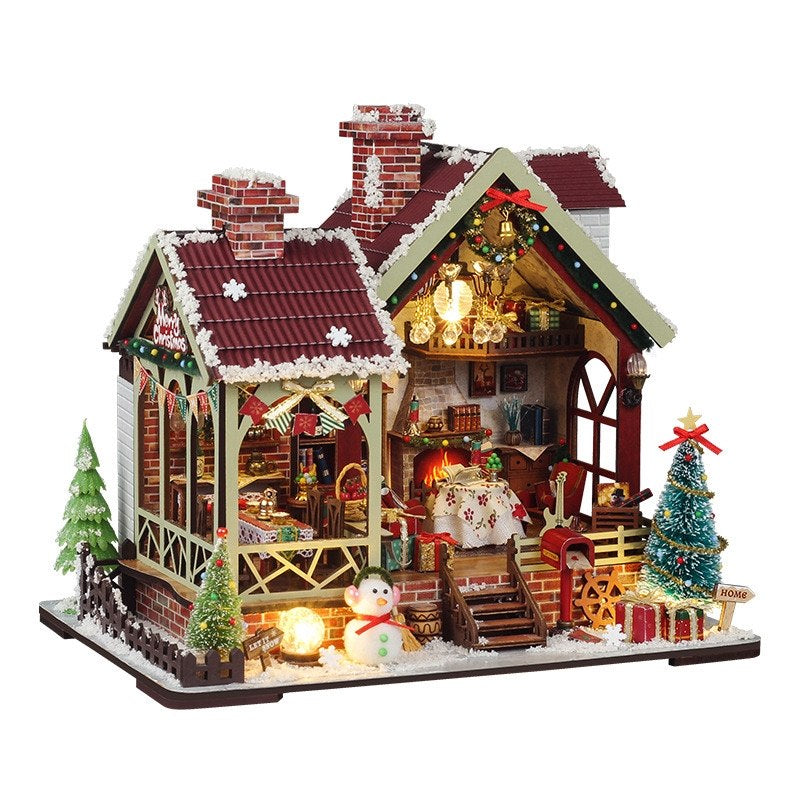 Decorative DIY Christmas house model with lights and miniature furniture on a white background