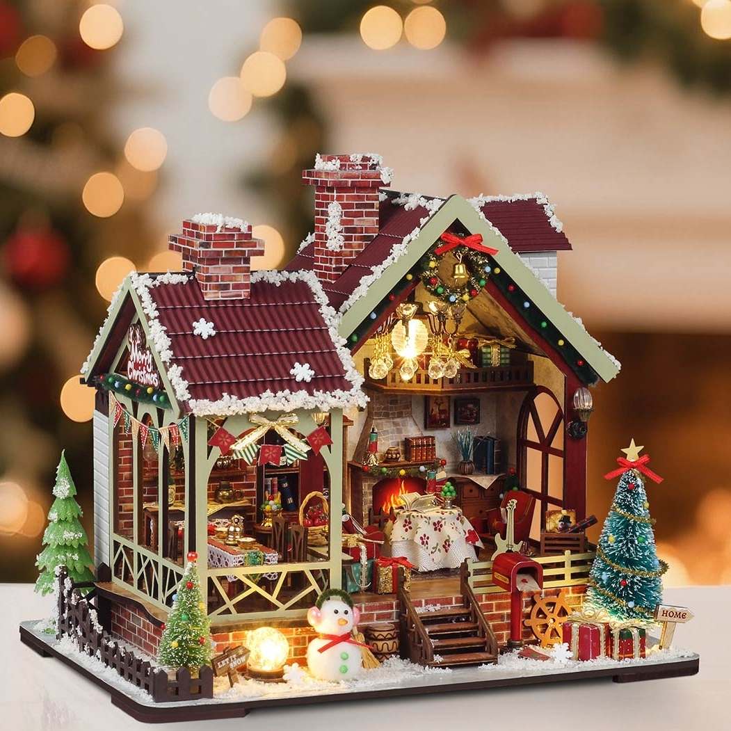 Decorative Christmas house model with lights and ornaments on a blurred festive background