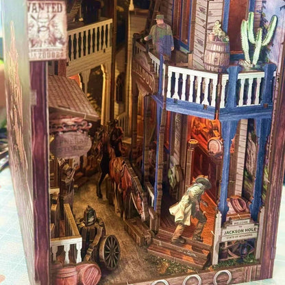 Detailed book nook model of a western town scene with people and buildings.