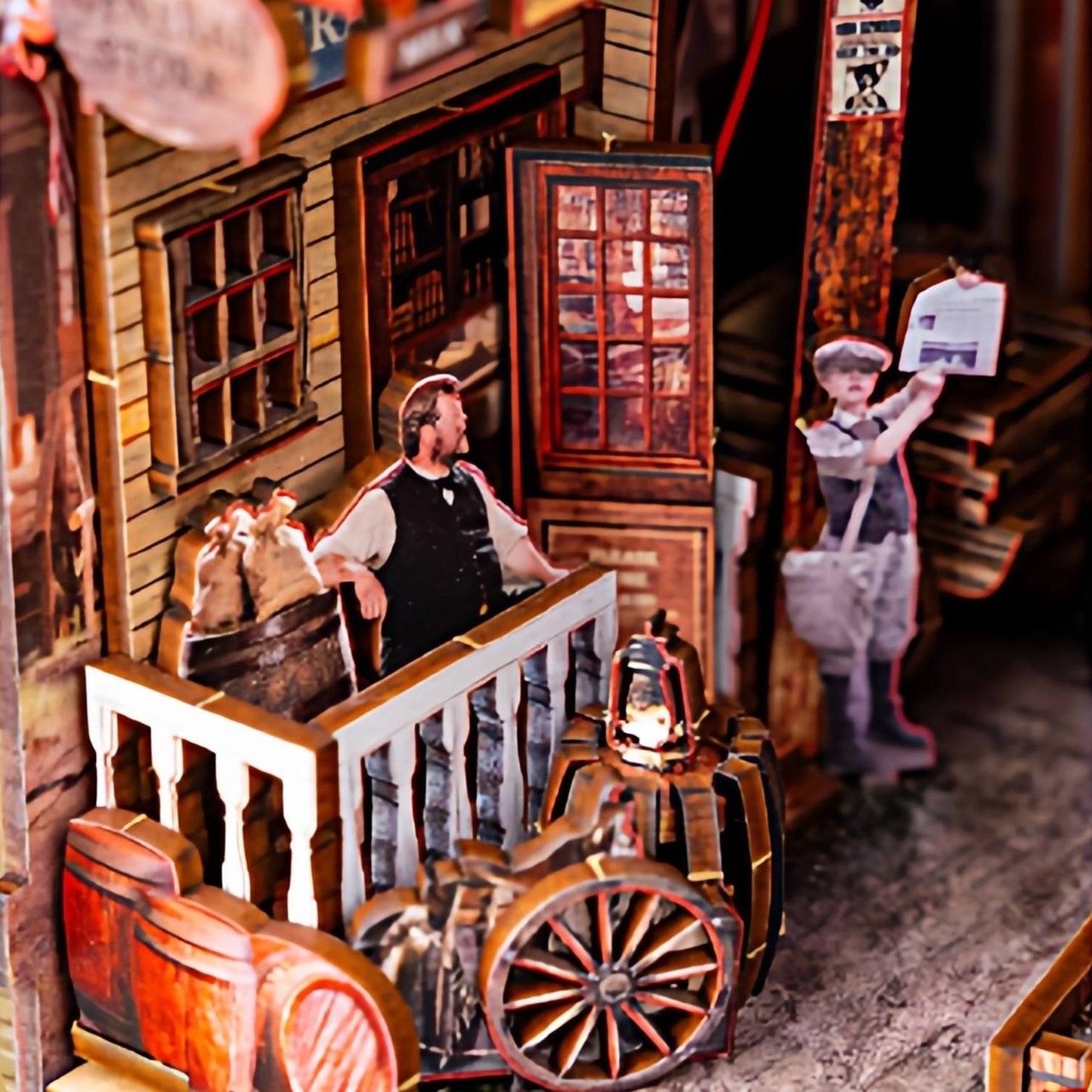 Detailed diorama model of a historical western town scene with people and a cart inside a wooden building.